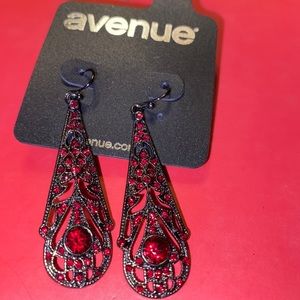 Never worn black earring with red stones